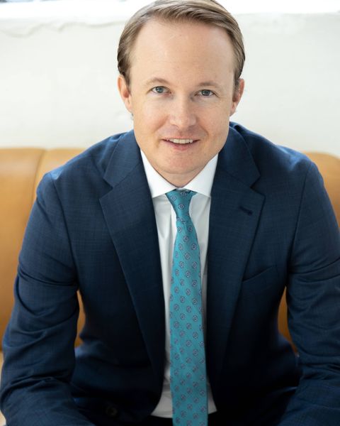 Professional headshot of businessman in suit